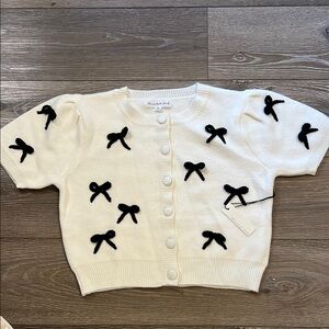 Cream Cardigan with Black Bow Accents